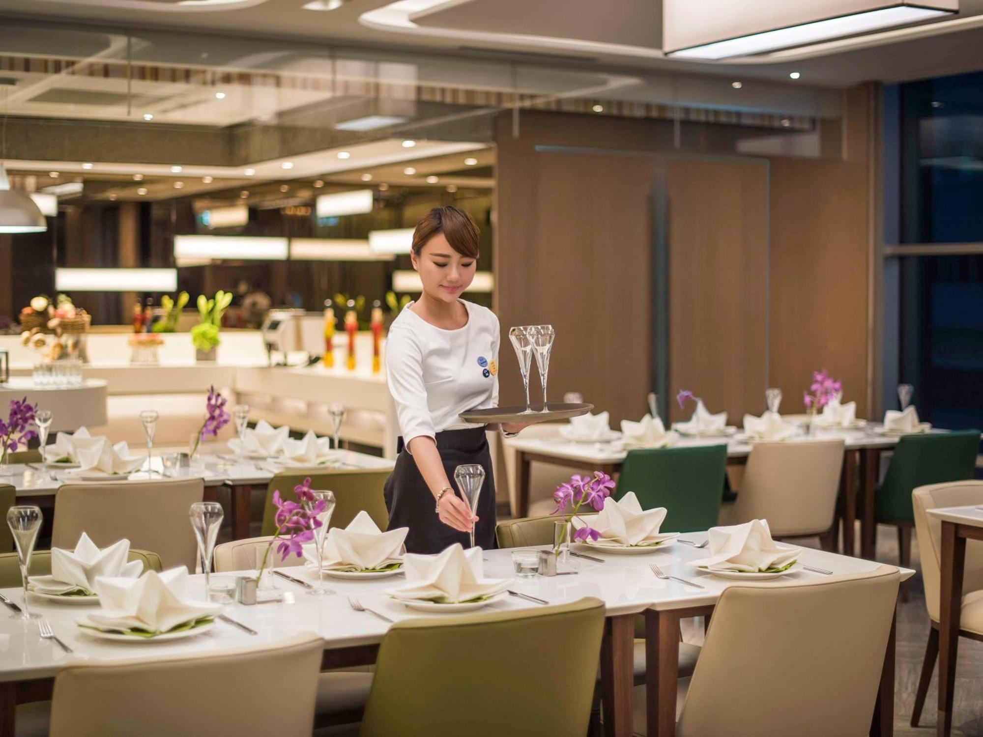 Hyatt Regency Taoyuan International Airport Hotel Exterior photo A Thai Airways flight attendant at the Royal Orchid Lounge at Suvarnabhumi Airport